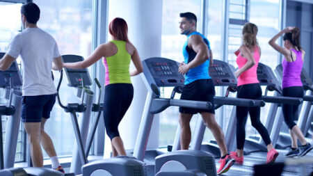 group-of-young-people-running-on-treadmills-in-modern-sport-gym